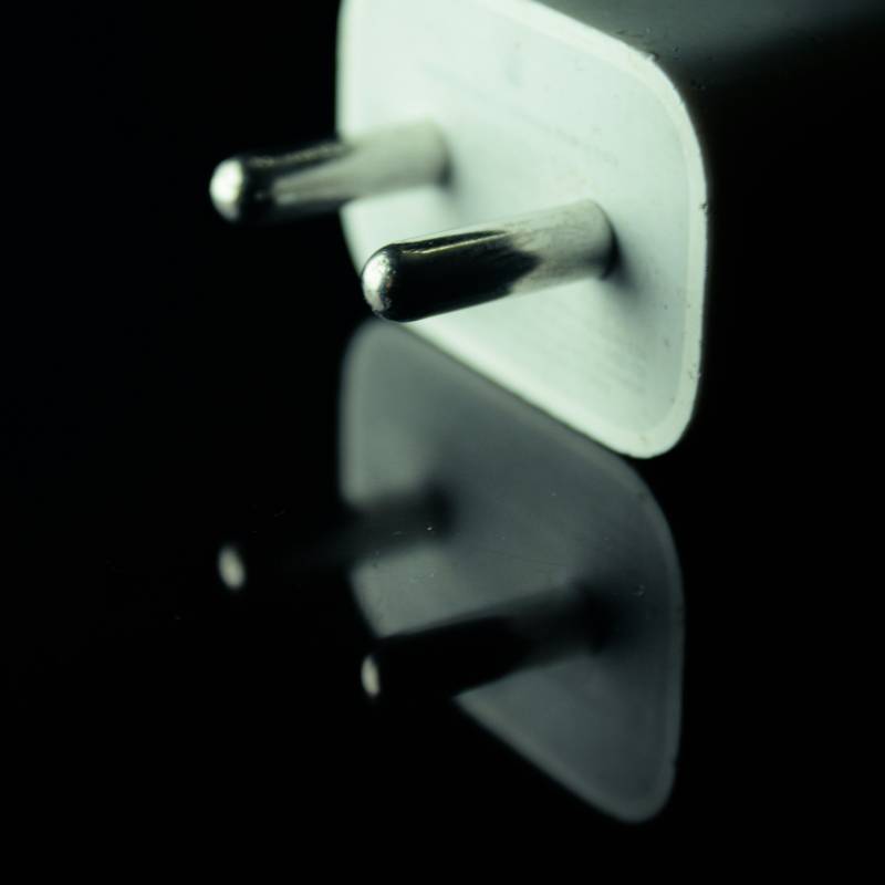 a close-up of white power adapter