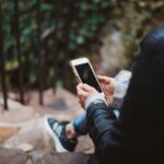 person holding a smartphone experiencing phone hanging problem