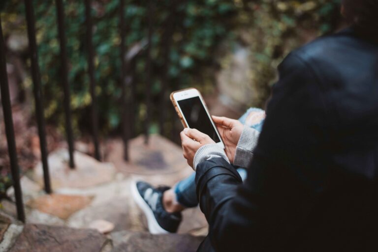 person holding a smartphone experiencing phone hanging problem